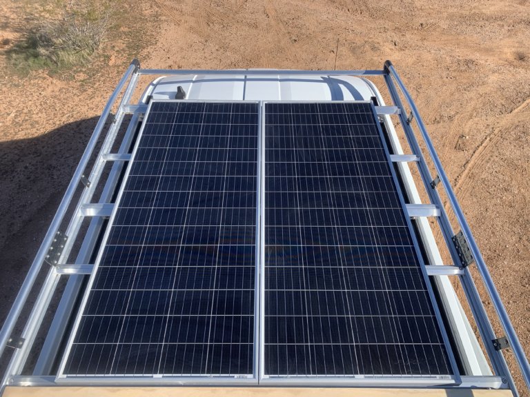 Two 210W NewPowa Solar Panels on the roof of a Ford Transit Van. Learn how to install them with no experience in this post.