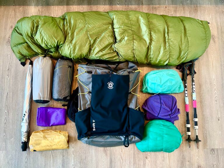 Thru-hiking gear laid out on a floor