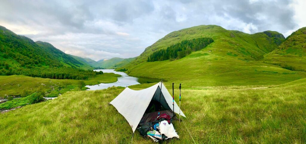 A tarp and bug net set up at a campsite in Scottland