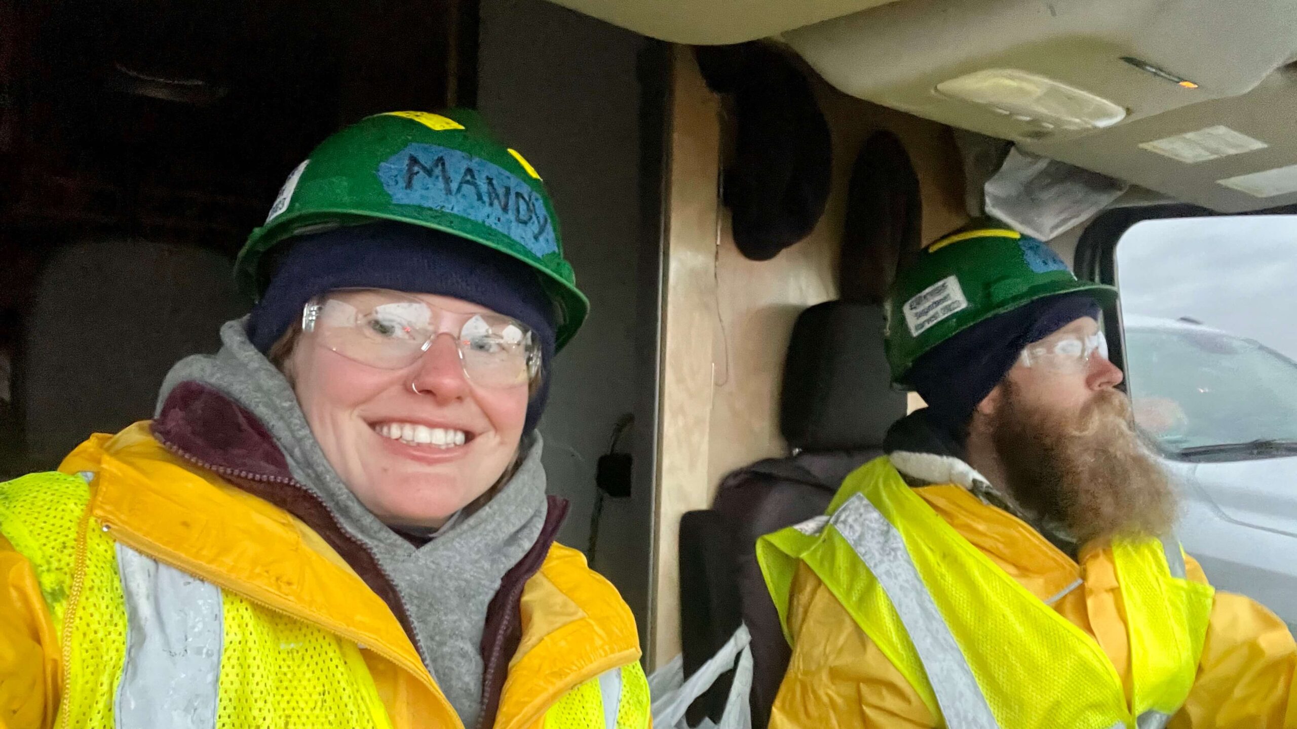 Two van lifers getting ready for work at the Sugar Beet Harvest in rain gear.