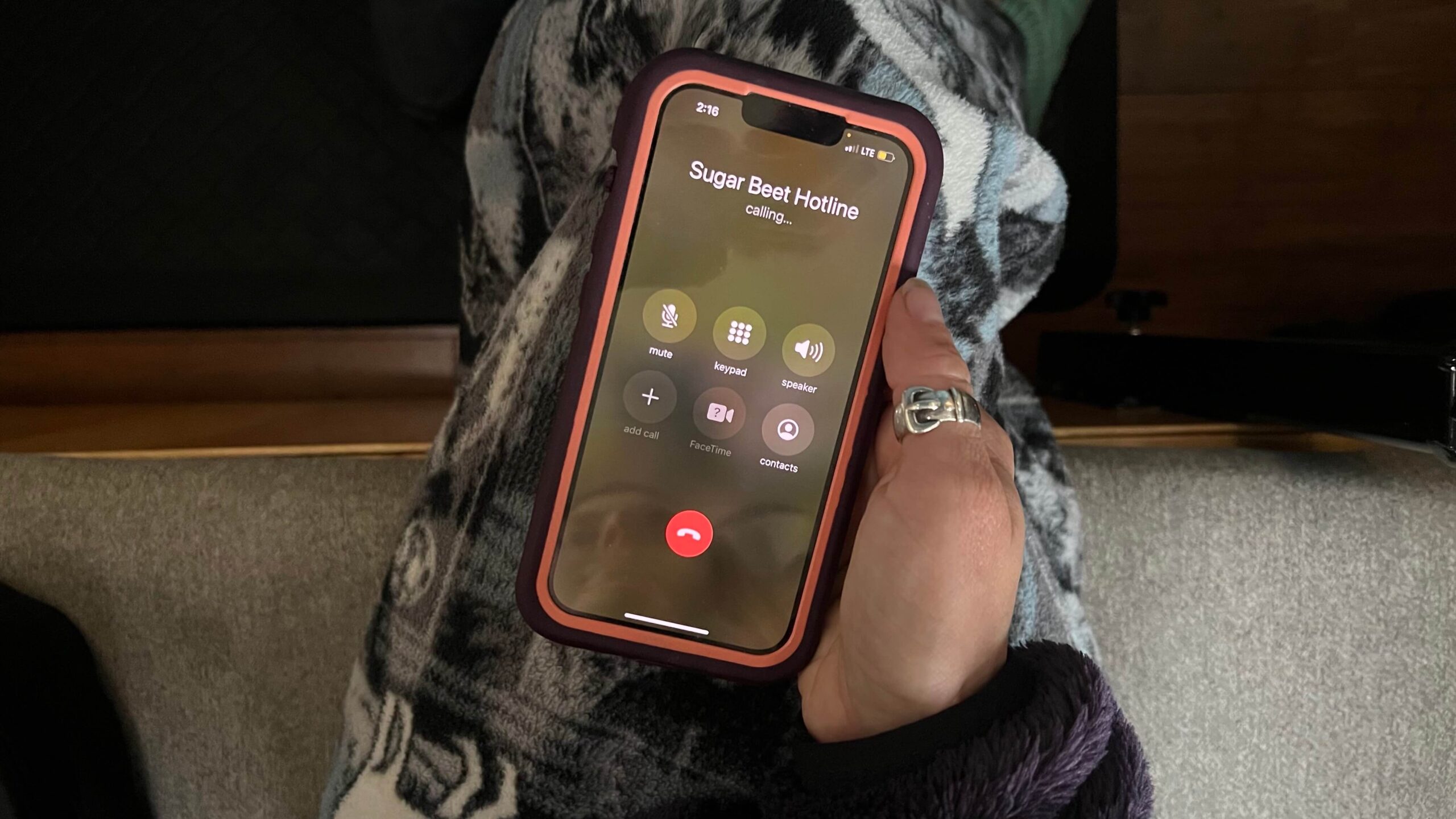 Woman about to call the hotline for the Sugar Beet Harvest before work.