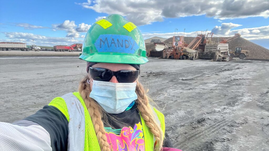 Selfie working the beet harvest with a piler and a pile of sugar beets in the background.