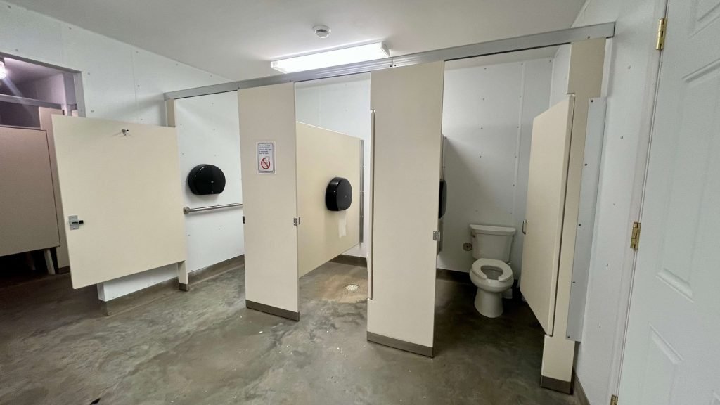 Three toilet stalls at the campground bathroom for the Sugar Beet Harvest.