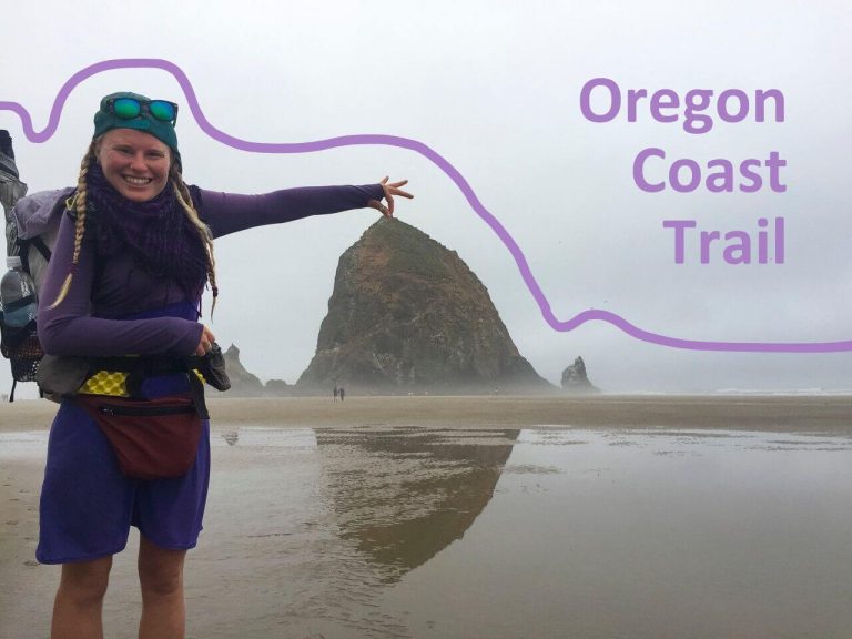 Woman thru-hiker on the Oregon Coast Trail pretending to hold a sea stack.
