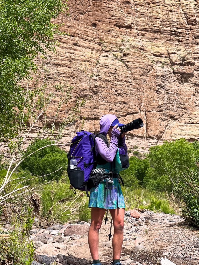 Woman thru-hiker and photographer in the desert.