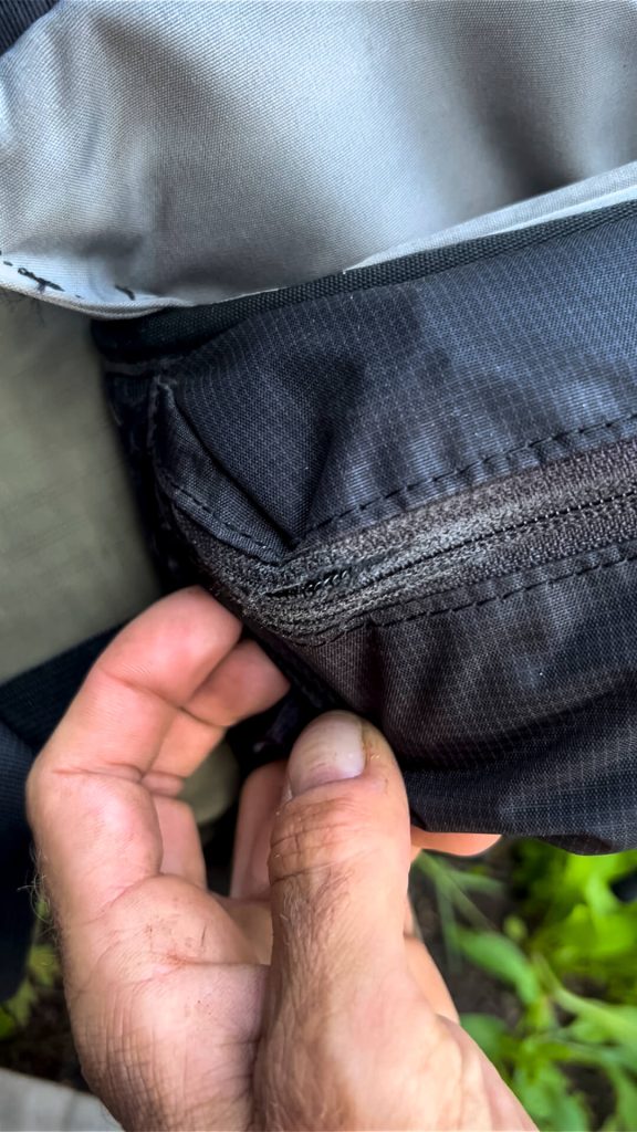 Wear and tear on the the hip belt pocket zipper.