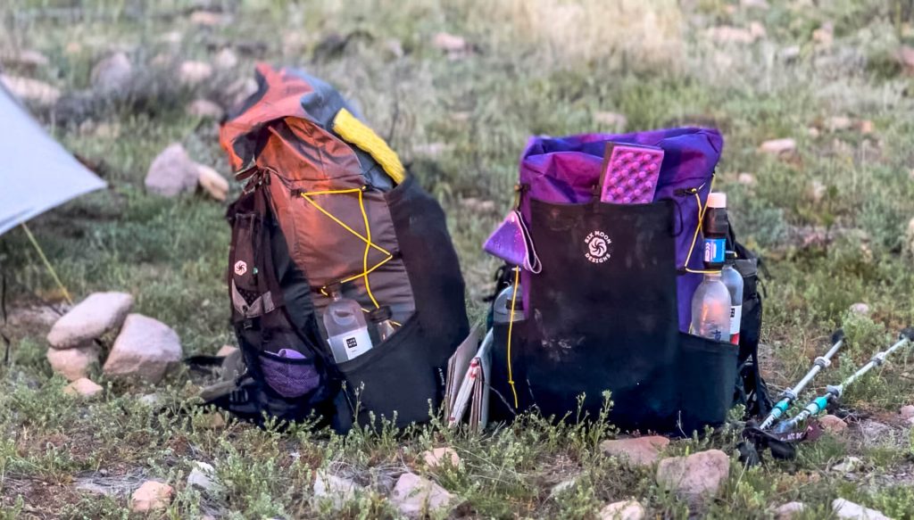 A Six Moon Designs Swift X (purple) and Swift V (gray) in the grass.