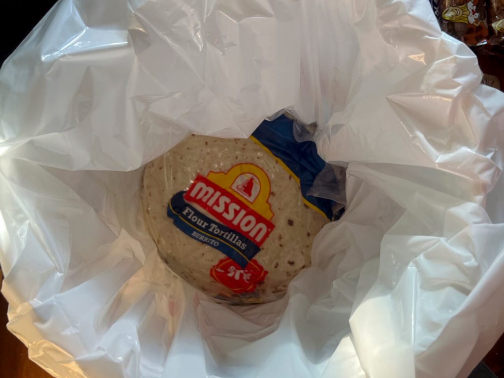 Tortillas at the bottom of a 5-gallon bucket.