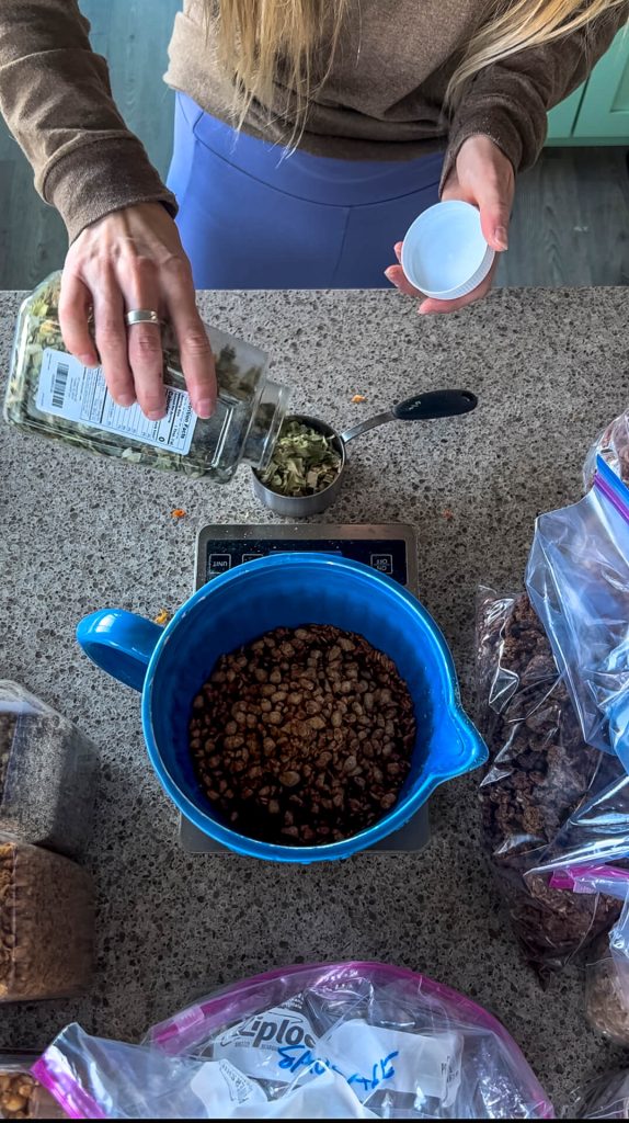 A bowl on a scale with dehydrated Chinese Food and a woman portioning out dehydrated vegetables.