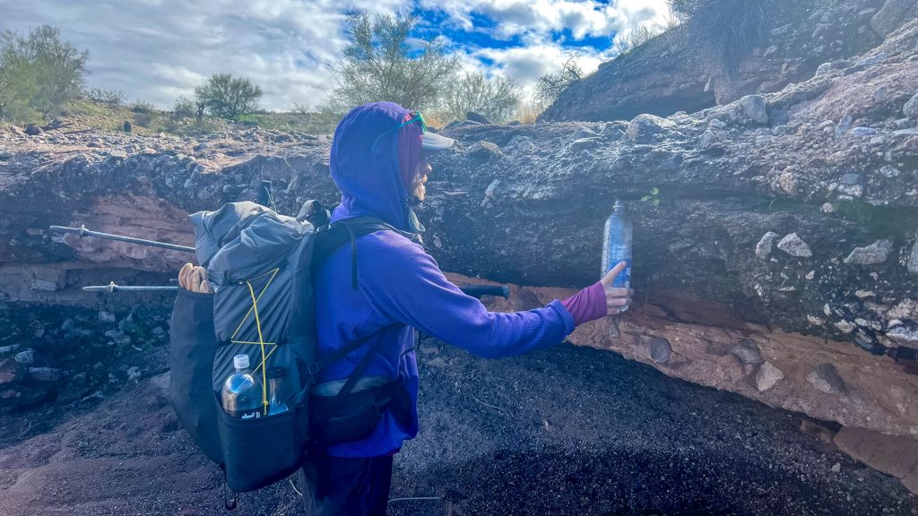 Thru-Hiker gets a small flow dirty water fill up.