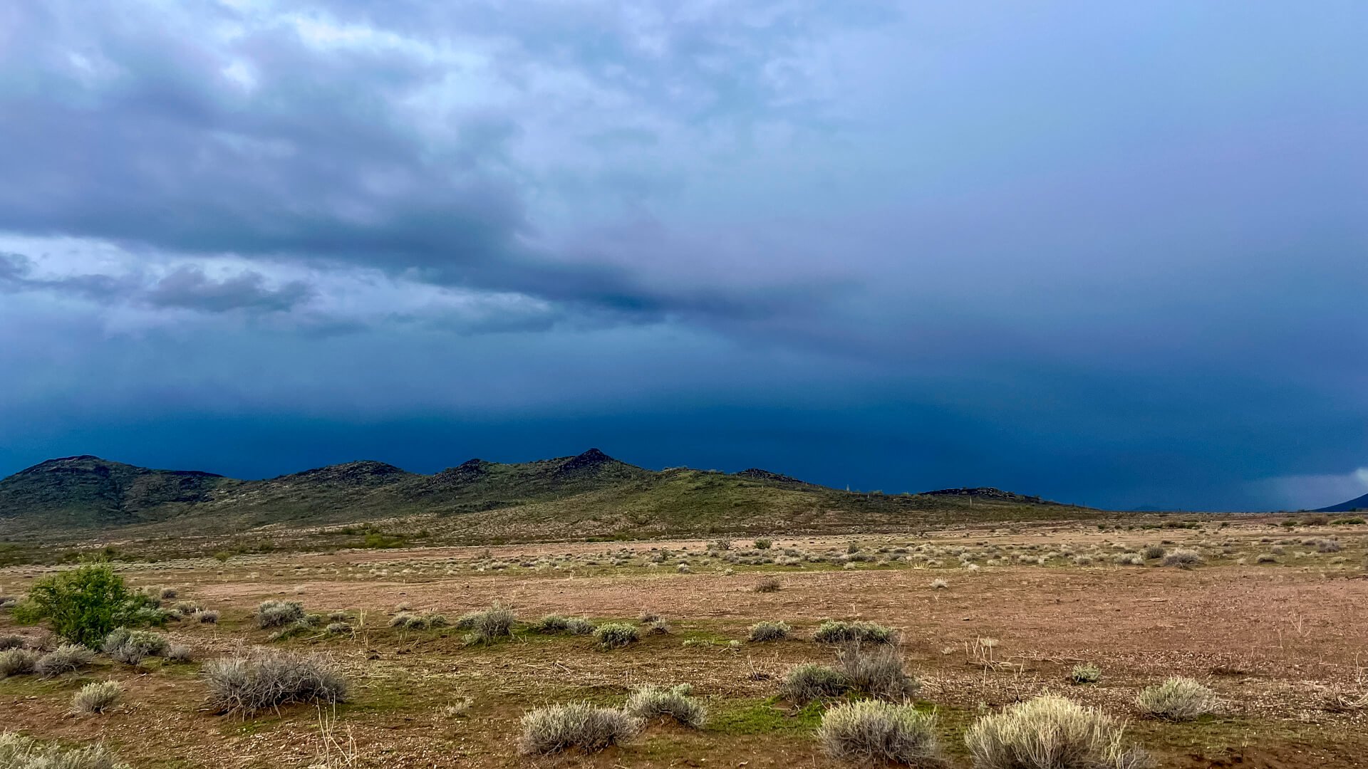 A storm on the horizon in the desert.