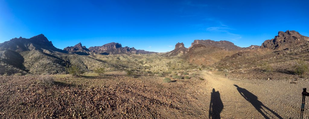 Two thru-hiker shadows going uphill toward the Whipple Mountains.