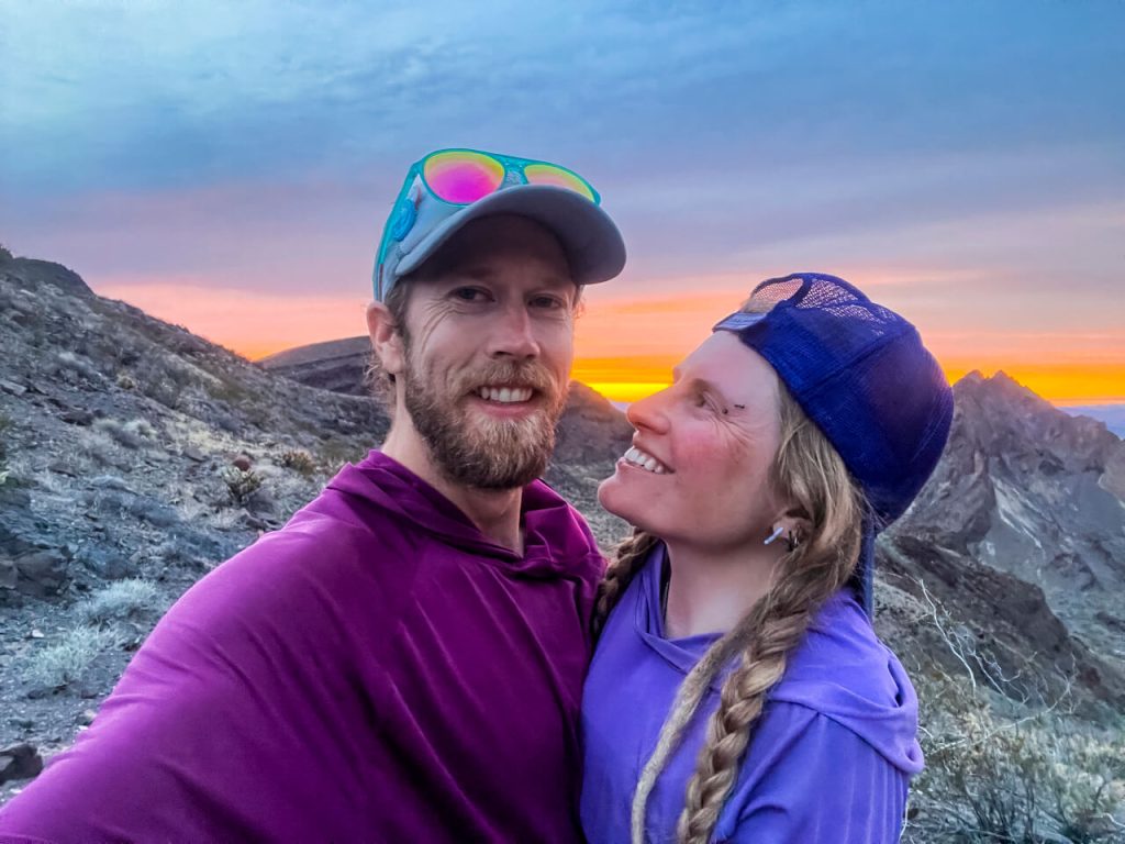 A thru-hiking couple in a sunset.
