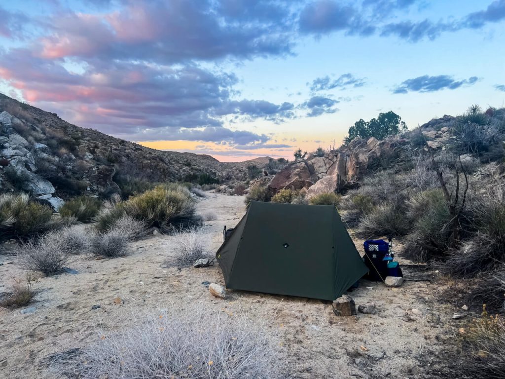 A low desert campsite with a bit of a sunset.