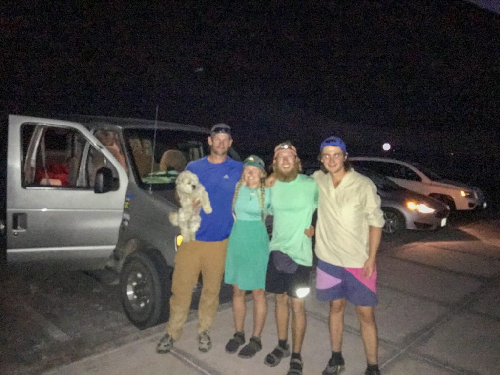 Three thru-hikers and their friend with a dog starting the Lowest to Highest Route at night.