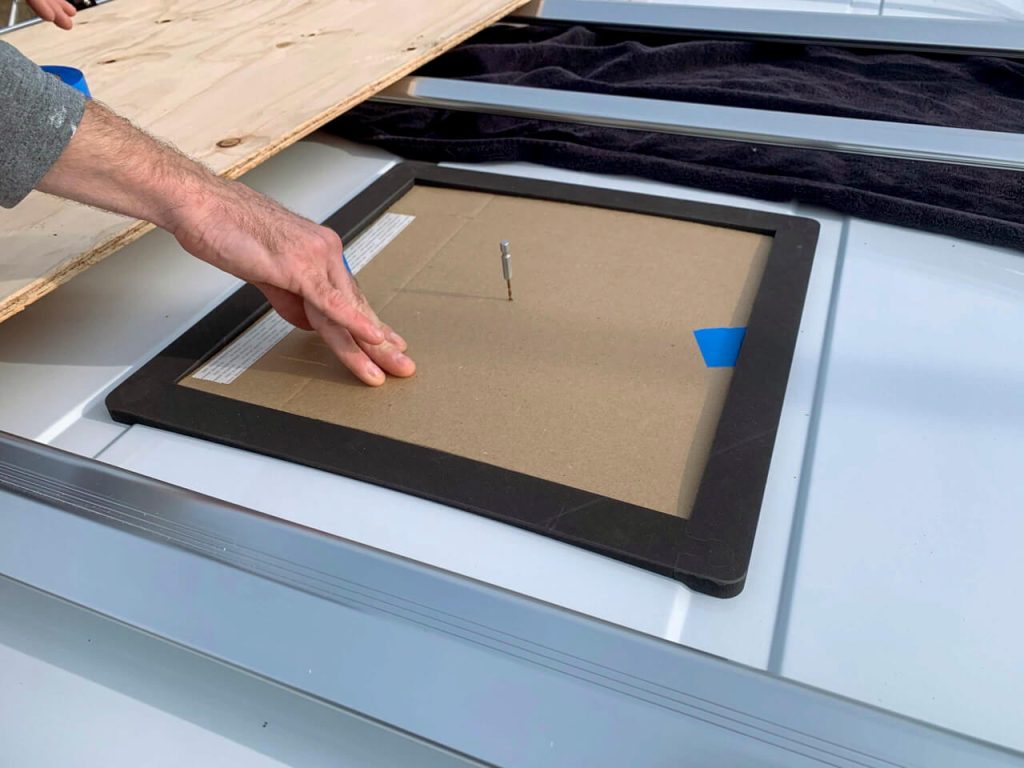 Placing the same template on the outside and finding it's spot with the center pilot hole.  A 3D printed template is also framing it, but not attached.