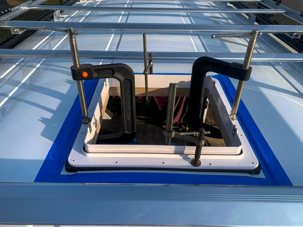 C-clamps holding the MaxxAir Fan pieces together to pre-drill the screw holes.