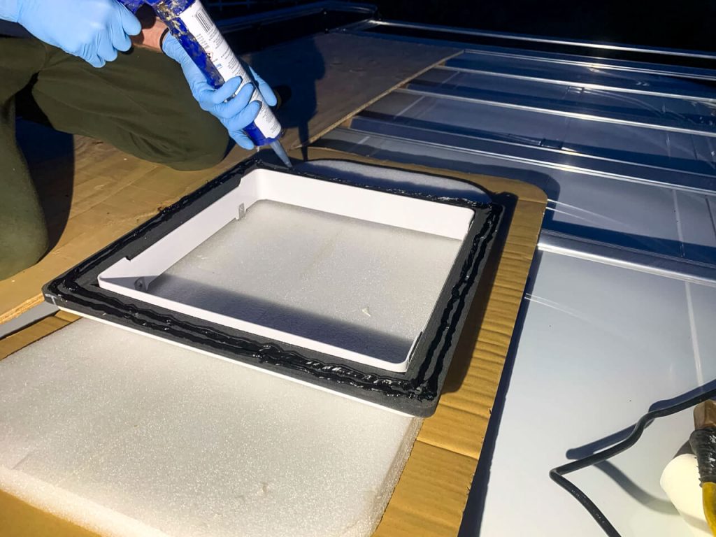 Adding 3M Window Weld to the 3D-printed template to attach it to the van's roof.