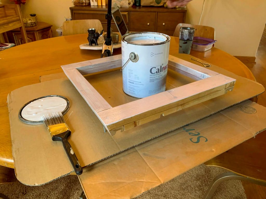 Prepping an under fan inside frame with mold and mildew prevention.