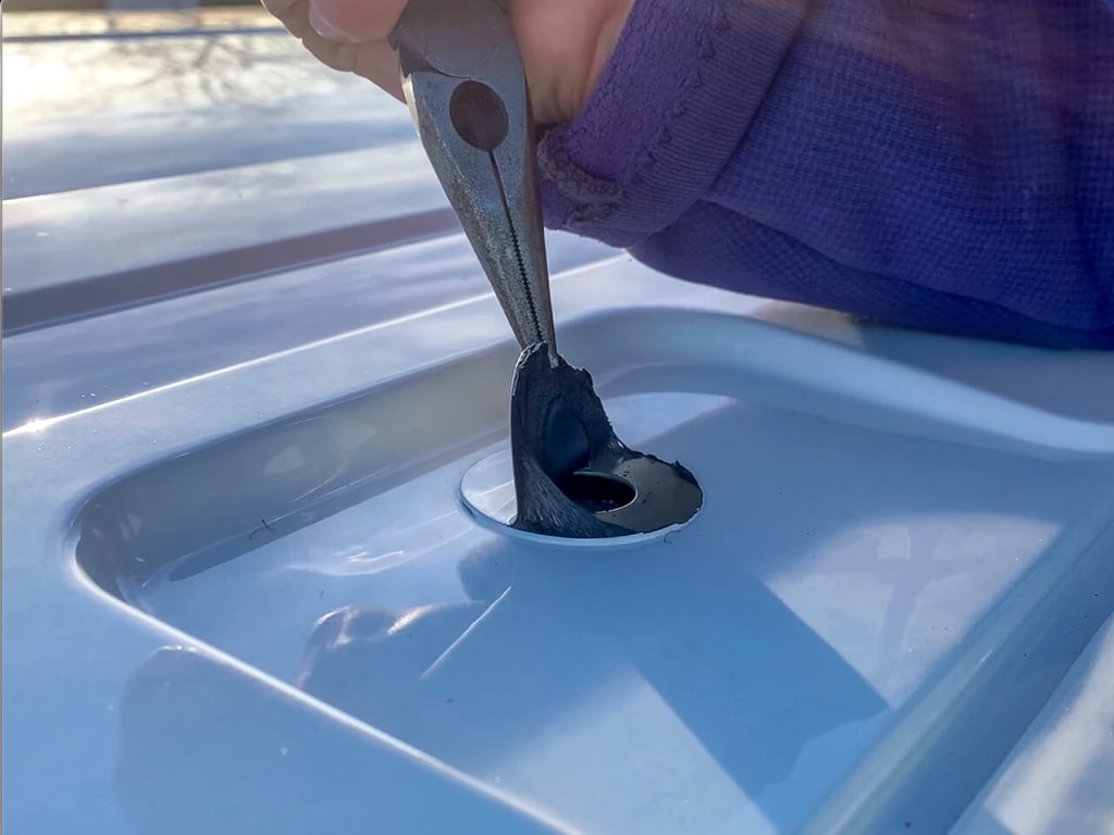 To gain access to the bolt holes for a van roof rack, remove the stickers; some might need pliers.