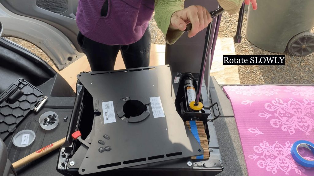 A graphic image of a way to expand the seat base slightly to align bolt holes. 