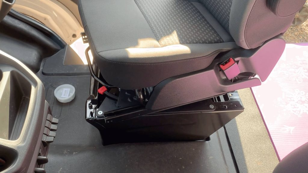 Adding the passenger seat back onto the swivel  and aligning the bolt holes.