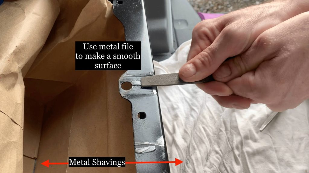 Use a metal file to file off the sharp metal and make it smooth.