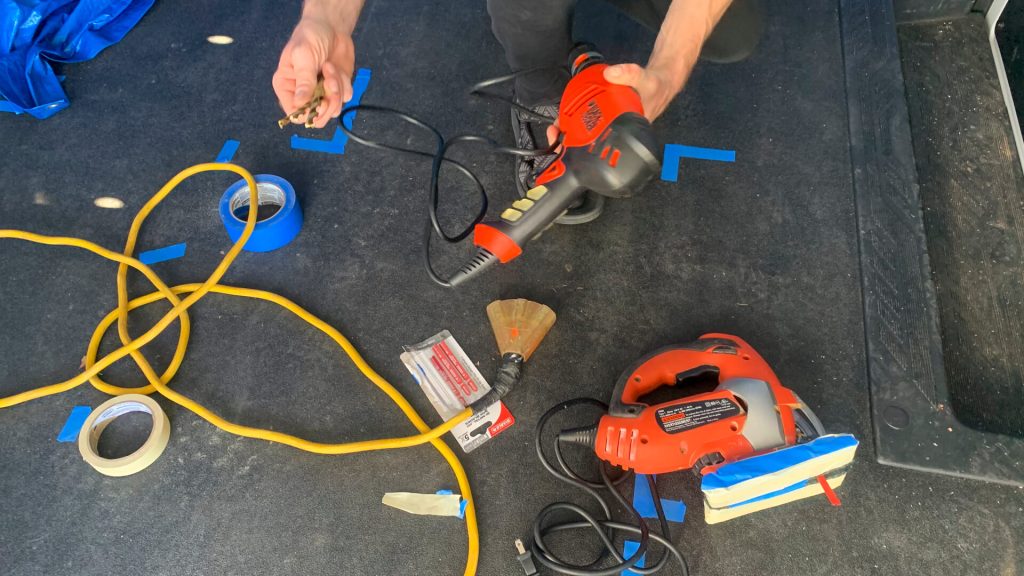 Tools gathered on the floor for a van project.