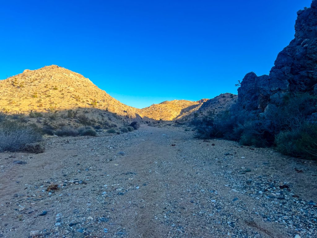 A desert wash walk in sandy terrain.
