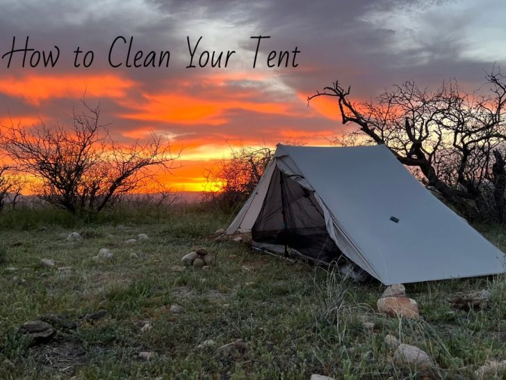 A tent set up in a desert sunset with text on how to clean a tent.