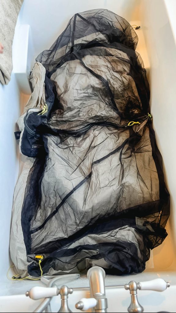 A dry tent going into a tub with a few inches of soapy water.