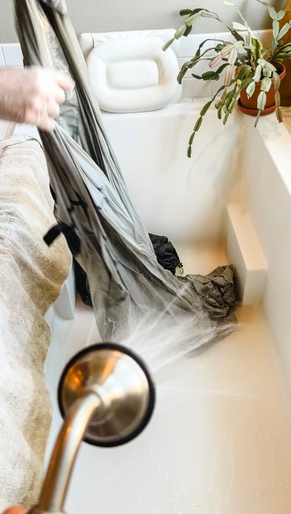 Thoroughly rinsing out the re-waterproofer from the tent.