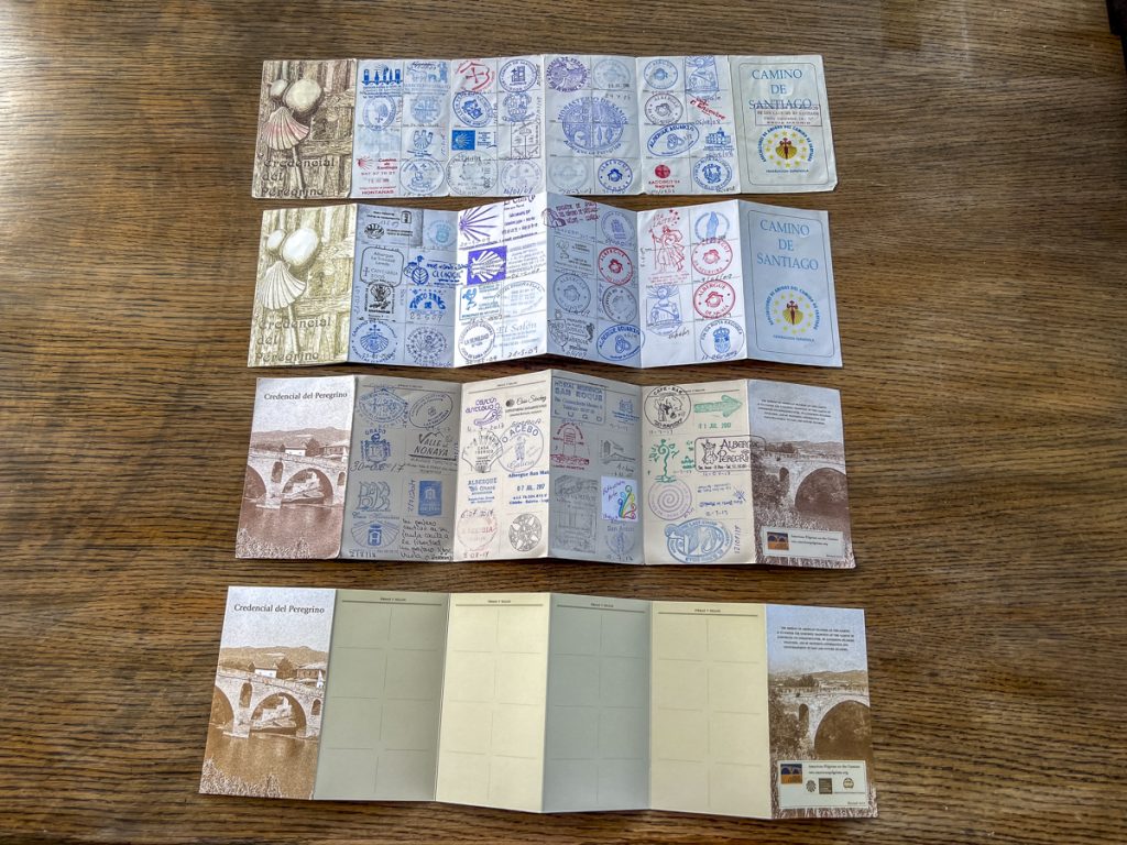 4 pilgrim passports, 3 used with stamps and one blank.