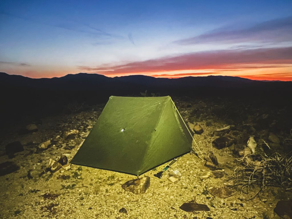 An evening sunset with the tent in the desert.