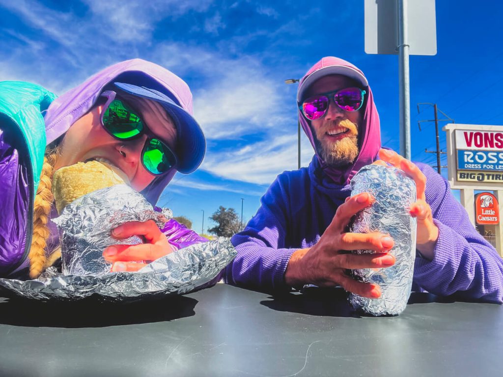 Two thru-hikers eating Chipotle burritos. 