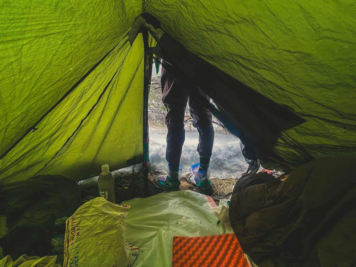 Looking out from inside the tent at the snowy mess.