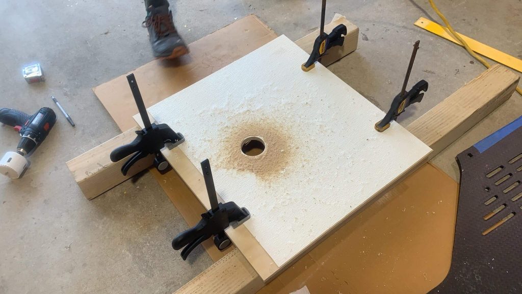 Cutting a hole in the van shower ceiling for a LED puck light.