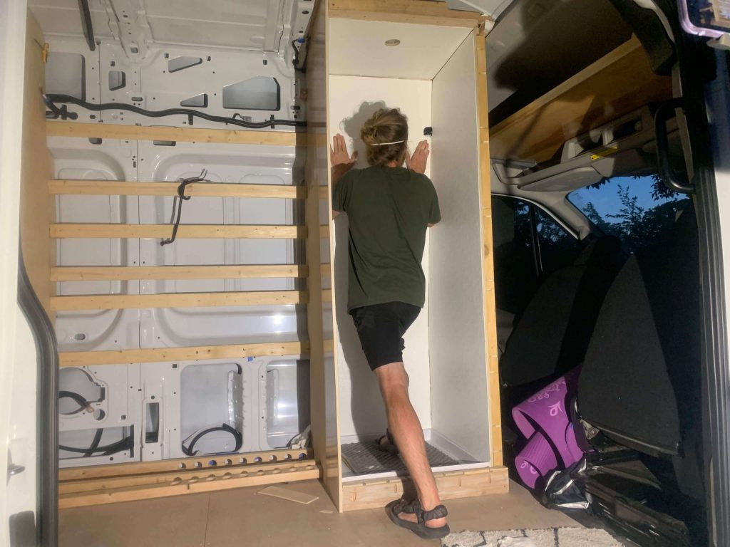 Pressing the FRP board to the glue on the walls.