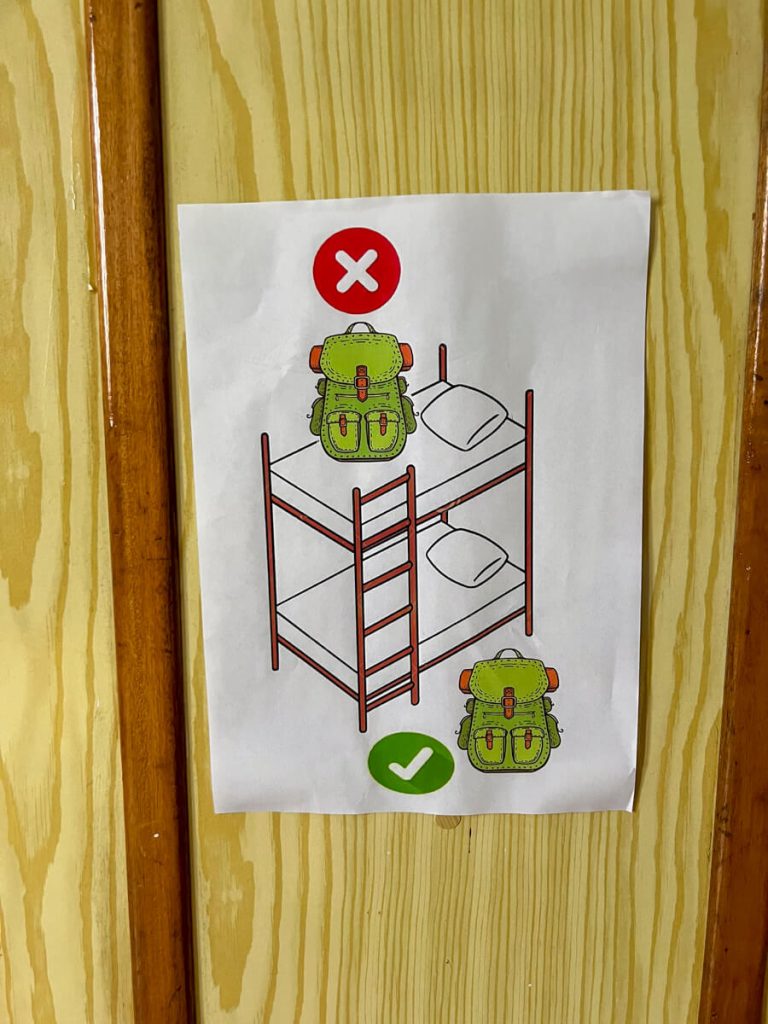A sign showing where to place your backpack.