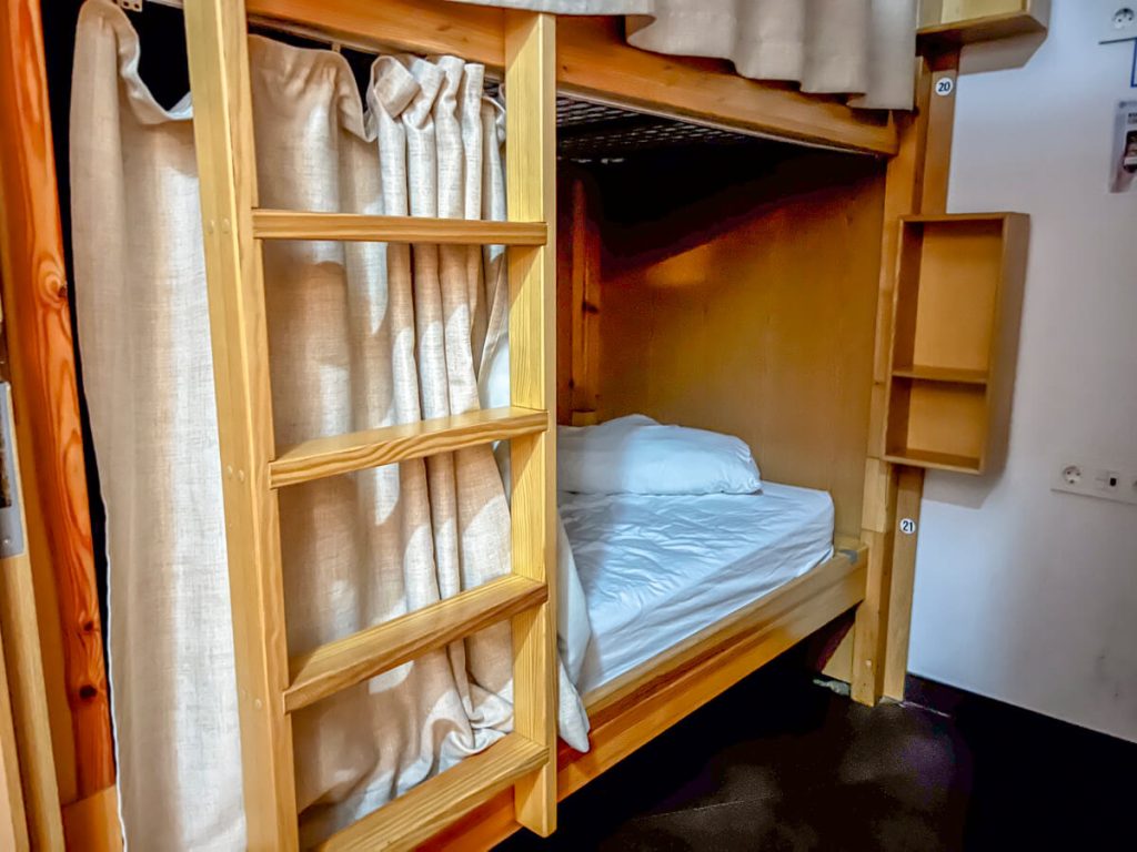 Albergue with wood bunk beds and wood baseboards.