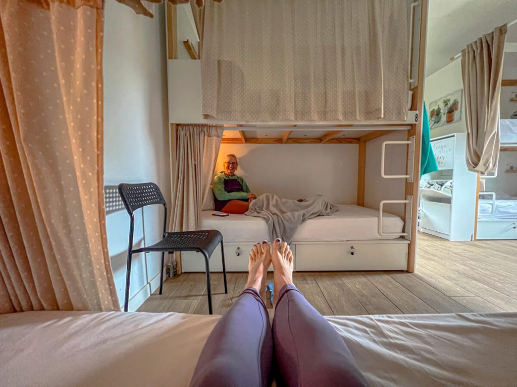 A private albergue with bunk beds that has drawer lockers at the bottom.