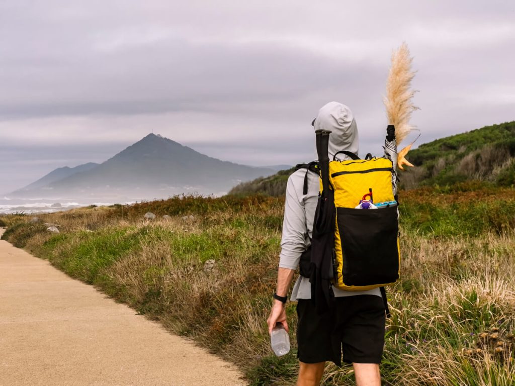 Karma walks along the Portuguese Coastal Route looking toward Spain (the mountain in the distance).