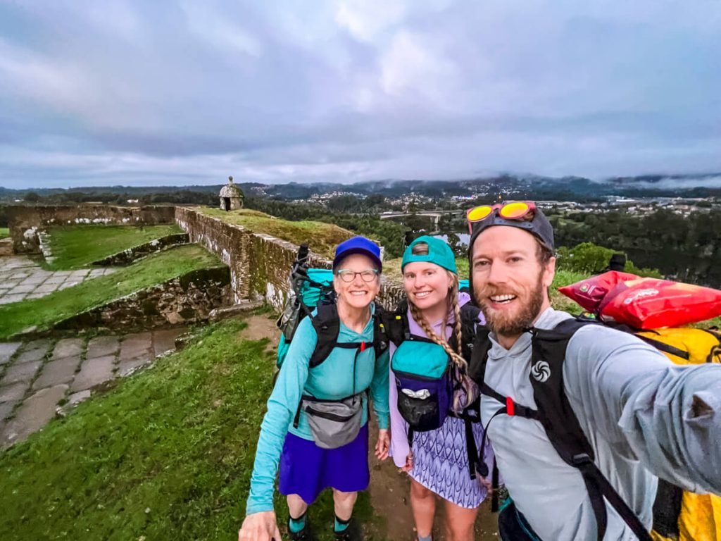 Three camino hikers on the old fort surrounding Valen&ccedil;a, Portugal on the Portuguese Camino.