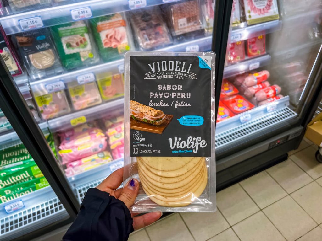 Vegan "cheese" is often available in mid-sized grocery stores in both Portugal and Spain.