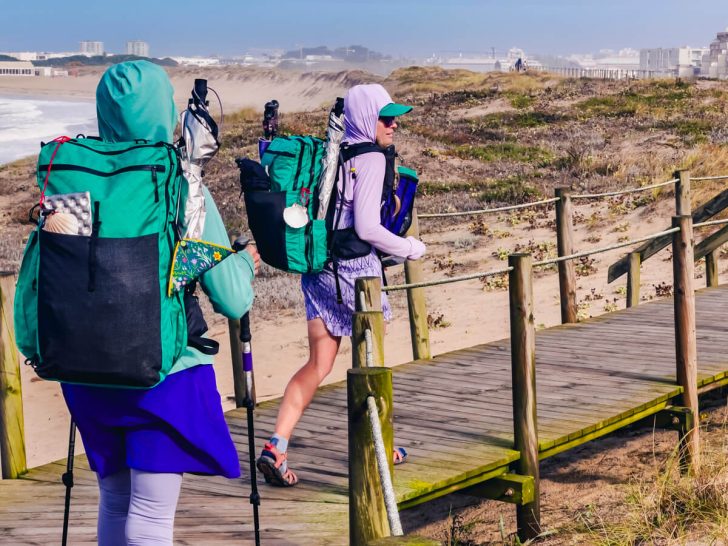 My Mom and I hiking on the Camino Portuguese Coastal Route on a boardwalk next to the beach.