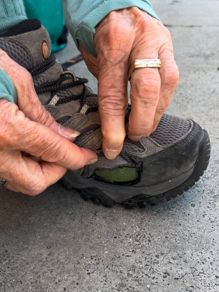 The hole we cut into my Mom's trail runner so she can avoid blisters while hiking on her bunion...but we have to cut a bit more.