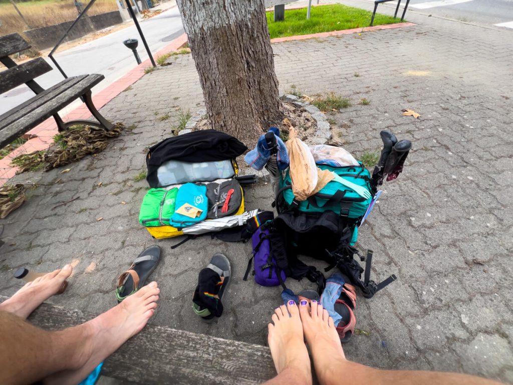 Two hikers taking a shoes and socks off break on the Portuguese Camino.
