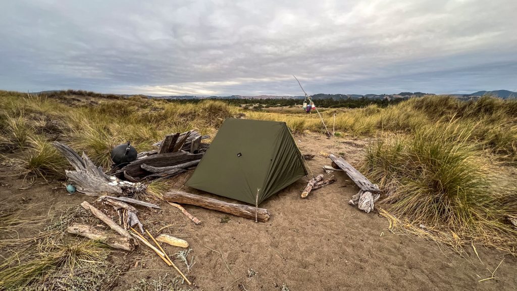 BLM primitive campsite on the Oregon Coast Trail marked by a stick and buoys.