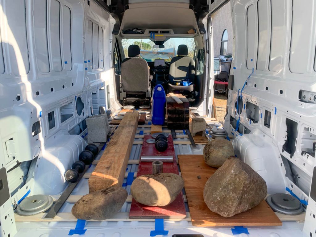 Weighting down the glued furring strips so the adhesive dries properly and it's used to weight.