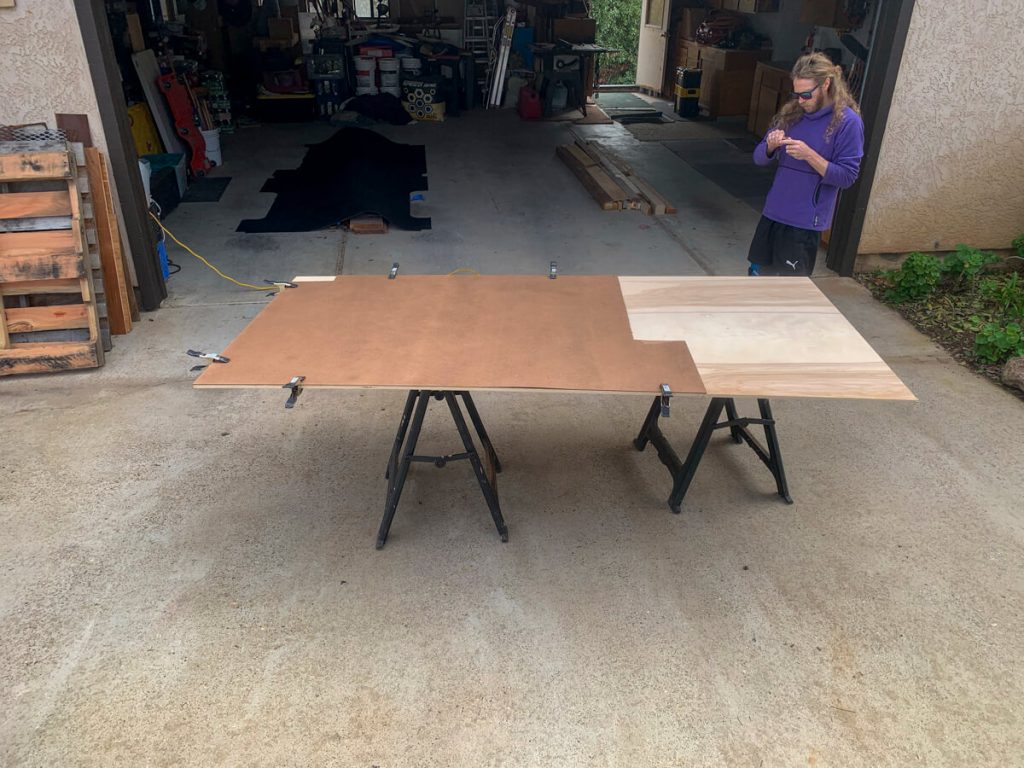 Using the template board to cut our van's subfloor panel.